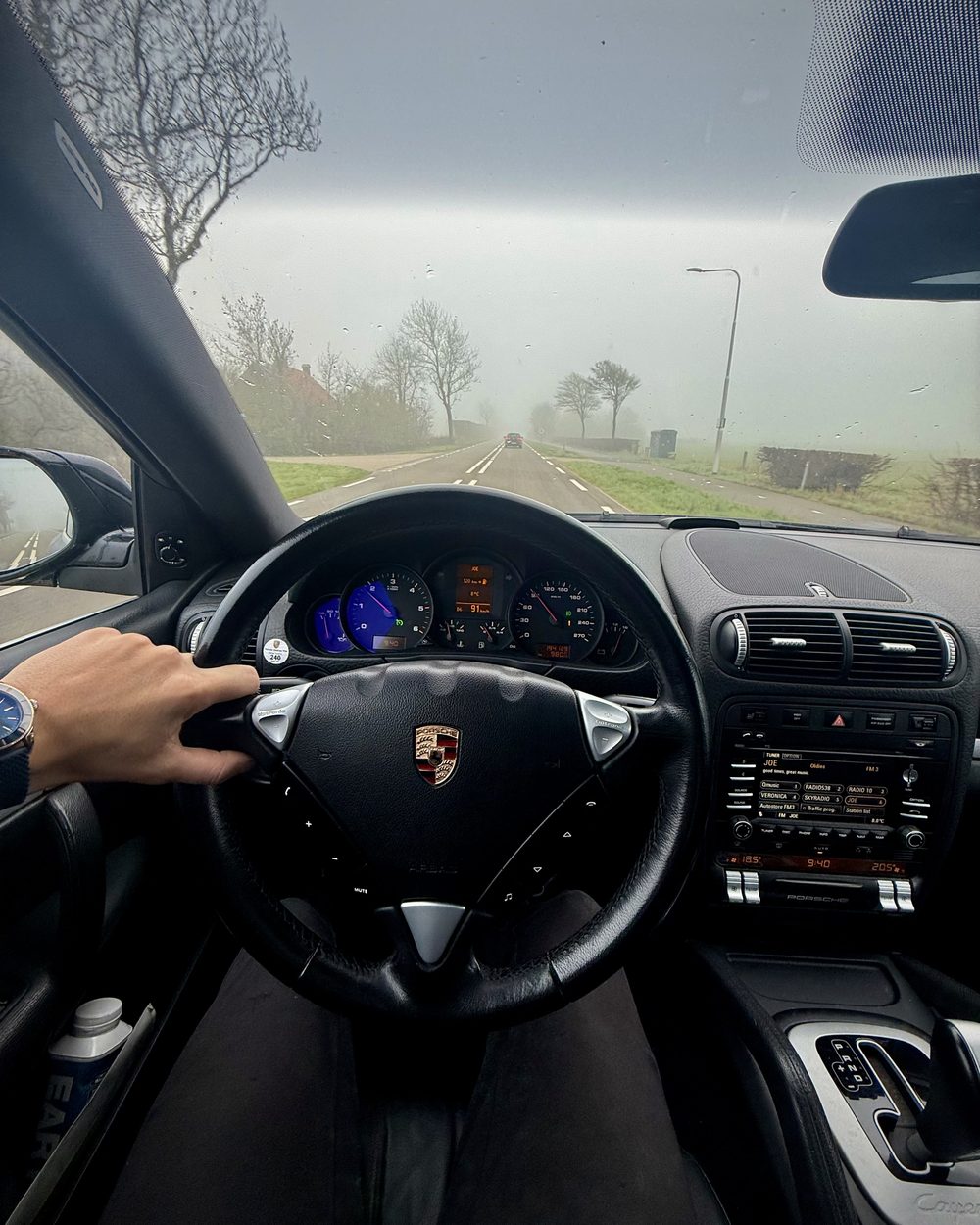 View from behind the wheel of the Cayenne on a misty Dutch road