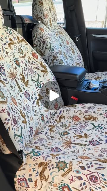 The custom seat covers Oma made for the Cayenne, with a colourful pattern of animals and plants